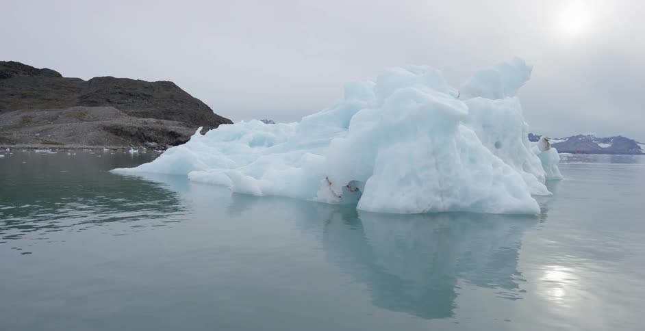An iceberg is floating near the shore