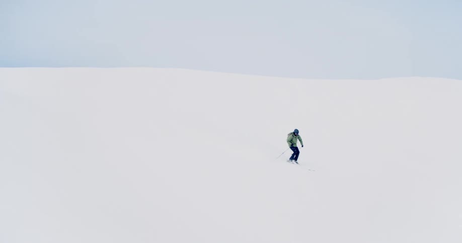 A person skiing down a snowy mountain