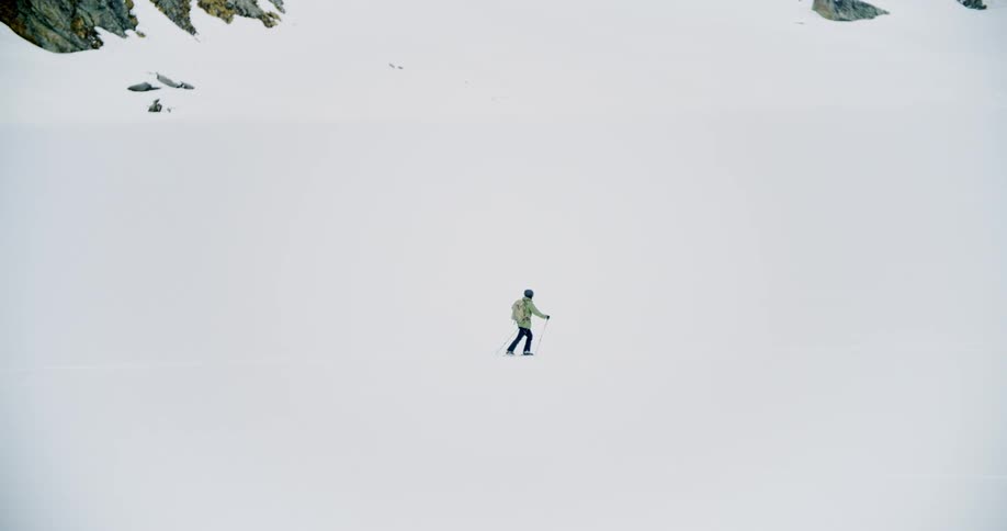 A person is walking through an arctic landscape