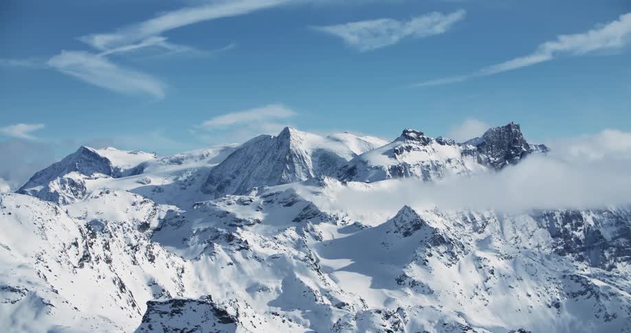 A mountain range covered in snow during the day