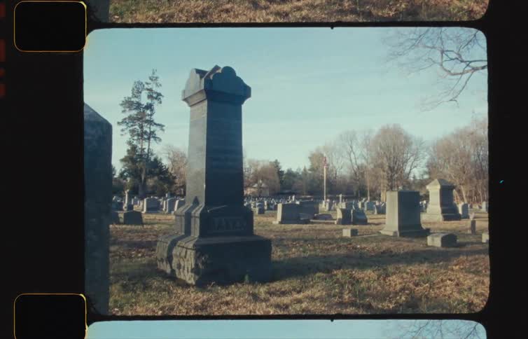 Wind blows past gravestones in a cemetery