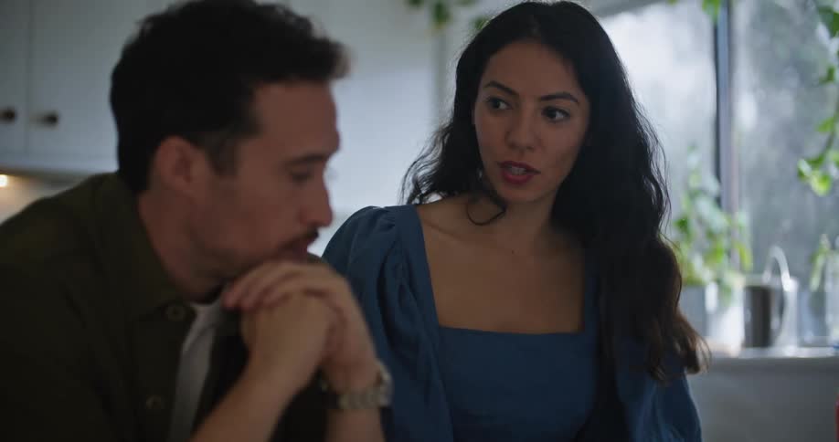 Man and woman at home during breakfast discussing something on the laptop
