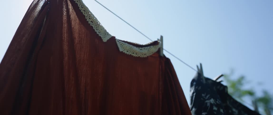 Dresses hung up on the clothes line during the day drying in the sun