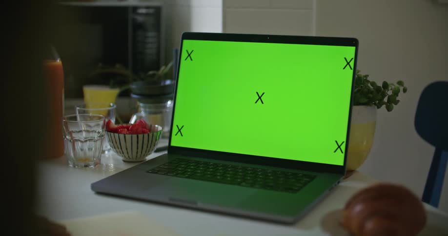 Person places bowl of food on counter near laptop