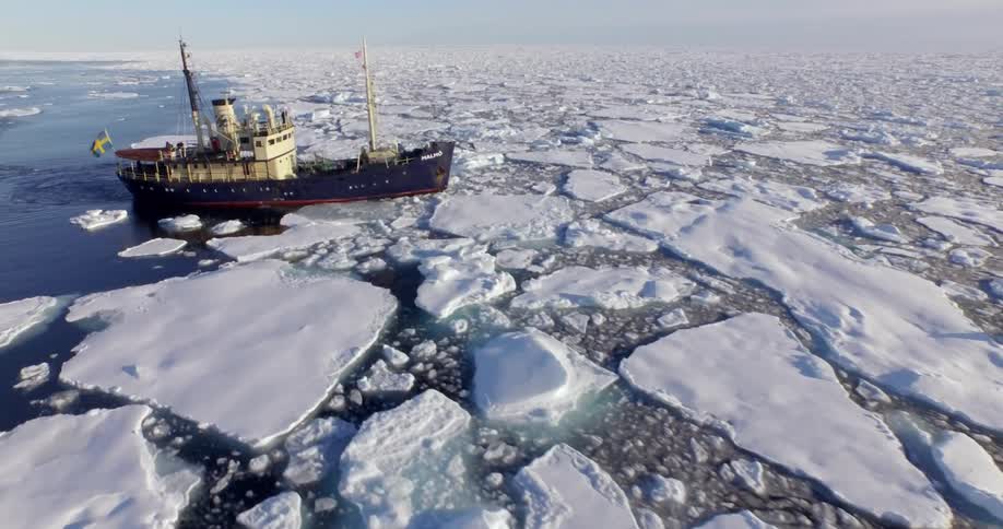 A large boat is sailing through ice filled water