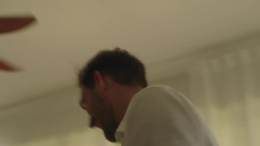 A man dances with his baby in his hands