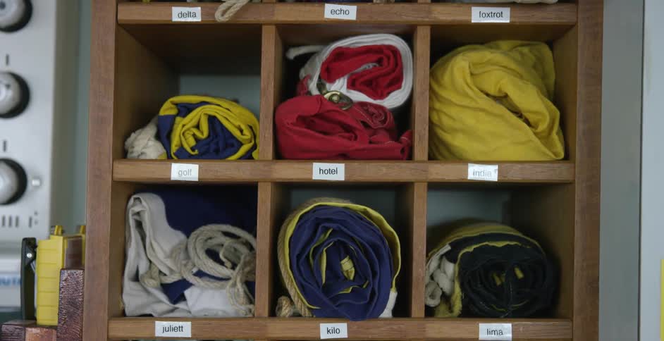 Shelves are tagged with names and filled with clothes