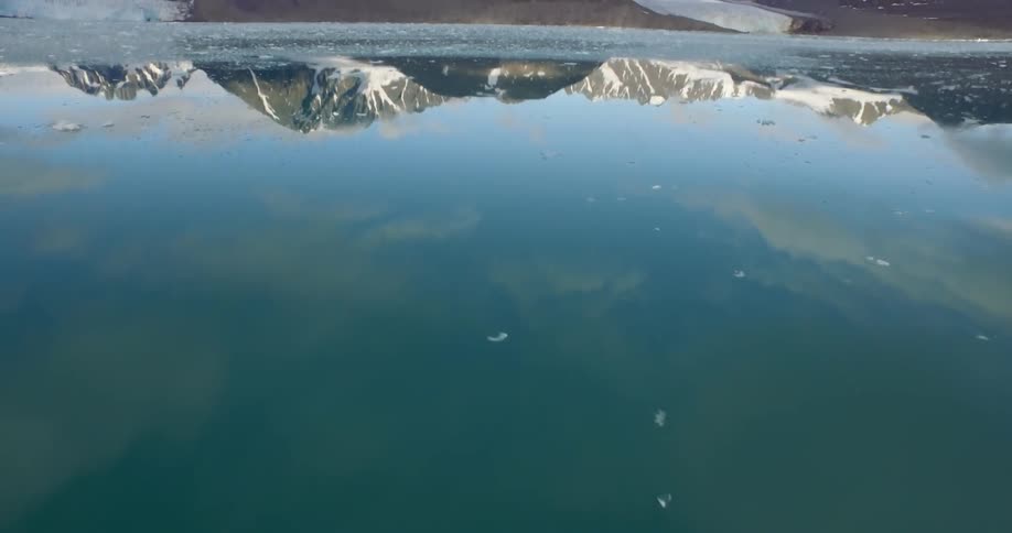The water is filled with ice leading to a mountain