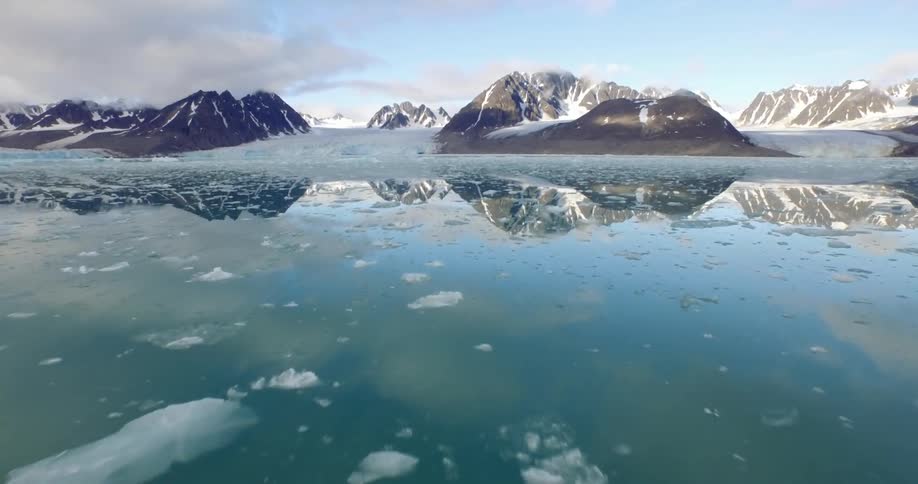 Any icy ocean reflects a nearby mountain range
