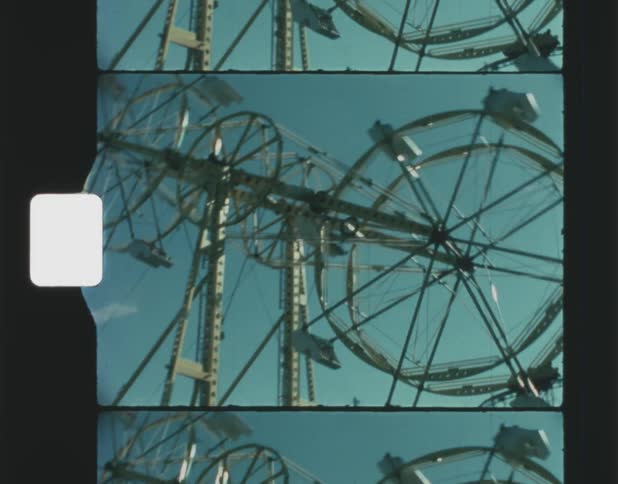 People ride on a large amusement park ride that spins and rotates