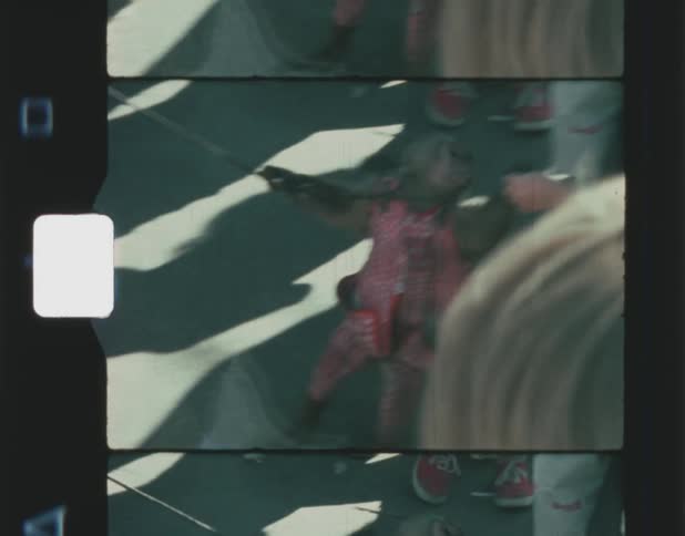 Old film footage of a monkey running in a group of people and shaking hands