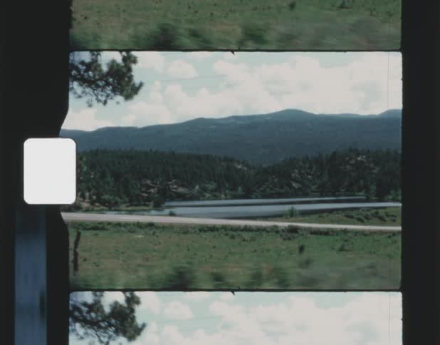 In the distance a lake can be seen below a mountain range