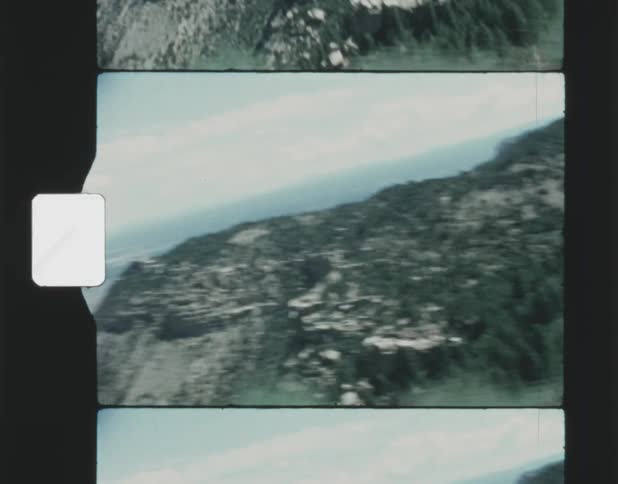 Film footage of a mountain range is displayed