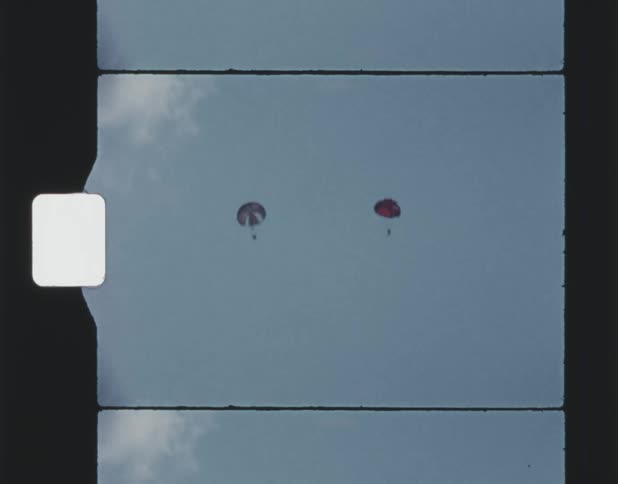 Vintage footage of parachutes people skydiving in the sky