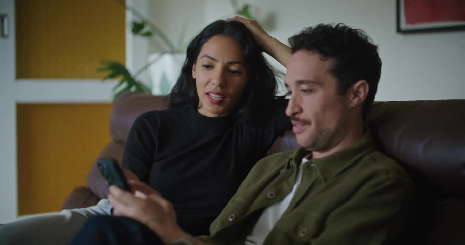 A man and woman using a smartphone together