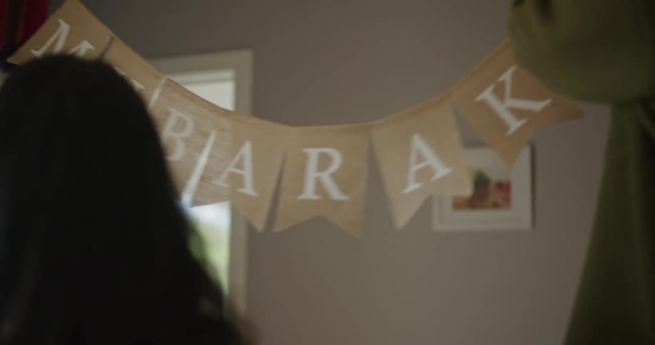 Man and woman decorate home for eid mubarak