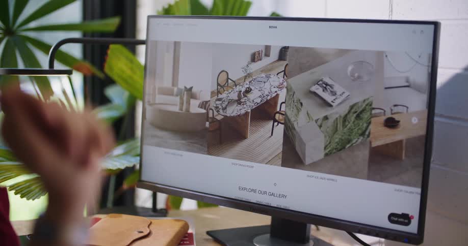 A person points to details shown on a large computer monitor