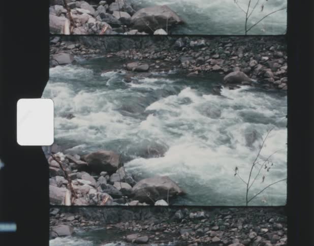 A small river rapidly flowing over rocks