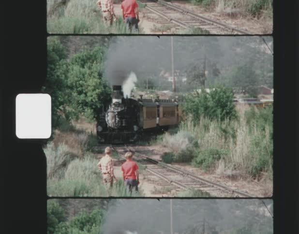 Two boys watching steam train running