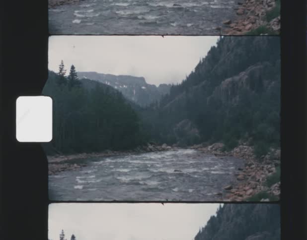 Vintage footage of river rapids through mountain pass