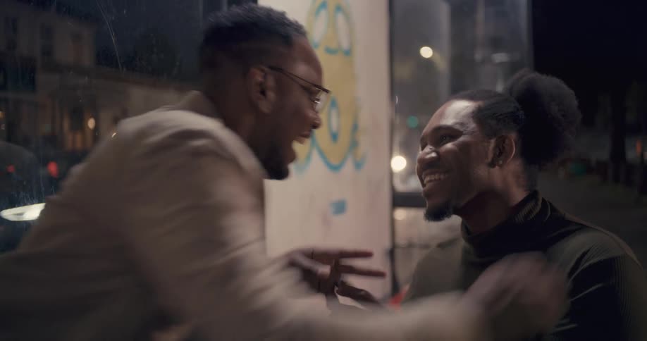 A man proposes to another man, putting an engagement ring on his finger and they hug