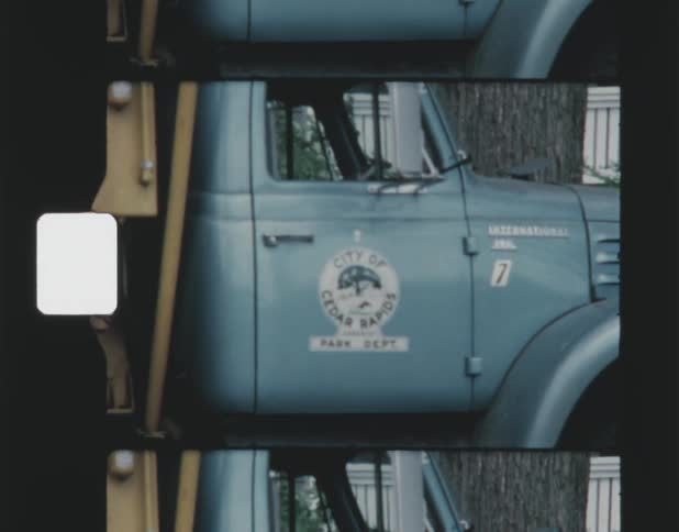 A older model truck with a logo on its door is park outside