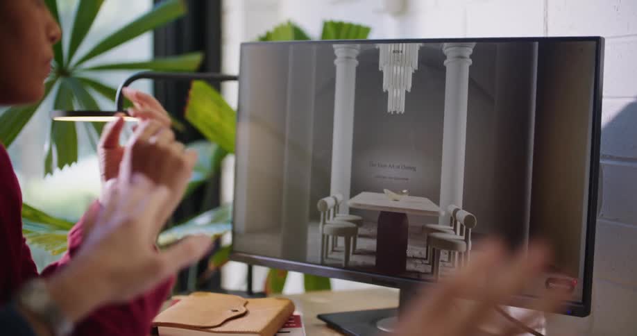 Businesswoman and businessman sitting at desk look at computer screen at the office