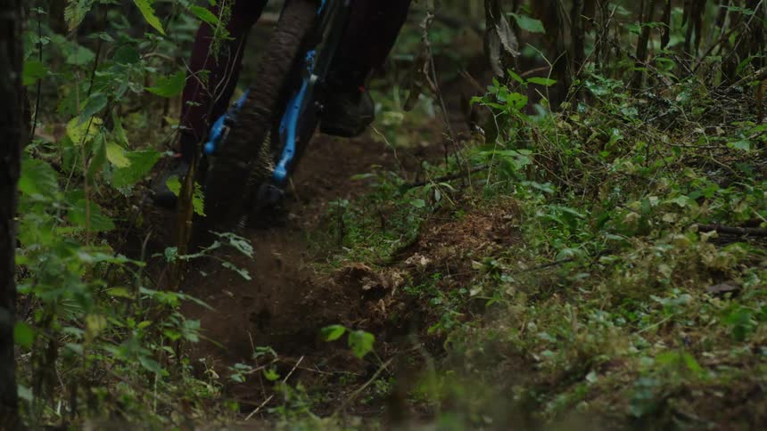 A person rides their bike through the dirt