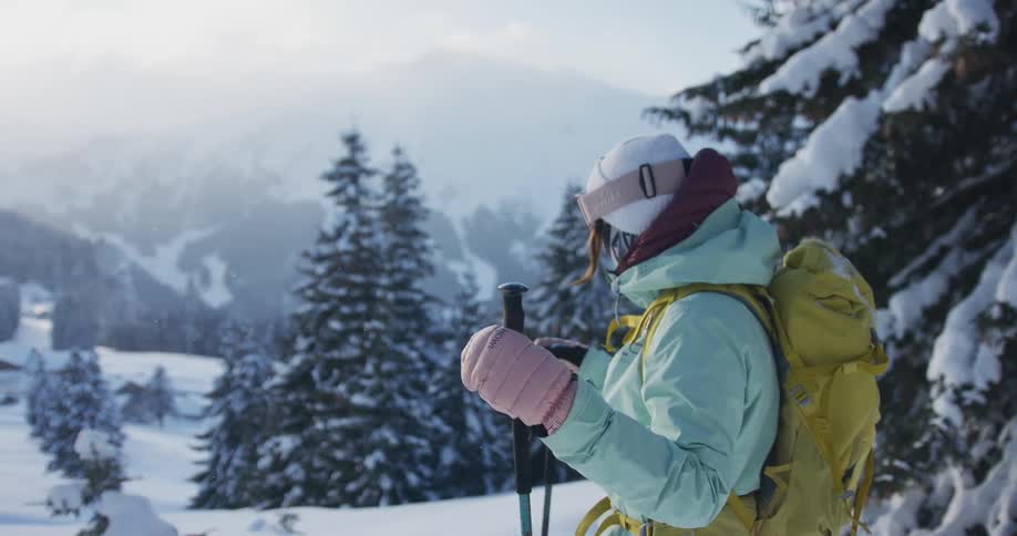 A woman is hiking in the snow