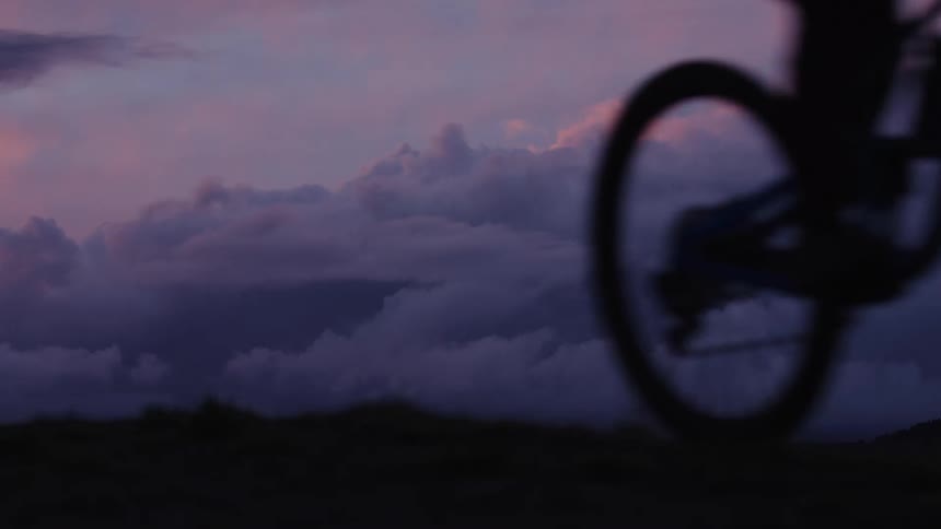 A man rides by on his bicycle