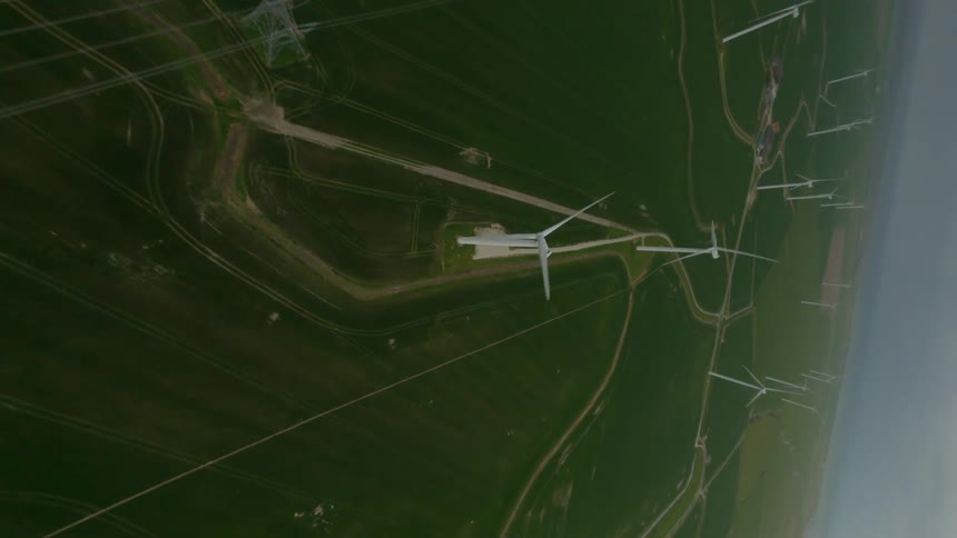 Aerial view of wind turbines on wind farm on a cloudy day