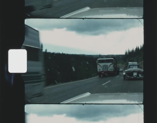 Cars are driving on a road during the spring time
