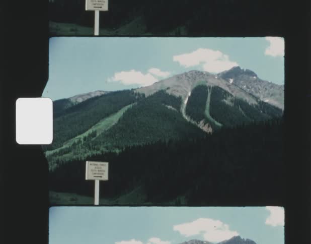 A sign is in front of the mountain