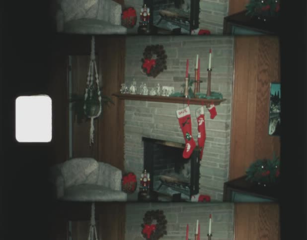 A pair of stocking hang over a brick fireplace in a living room
