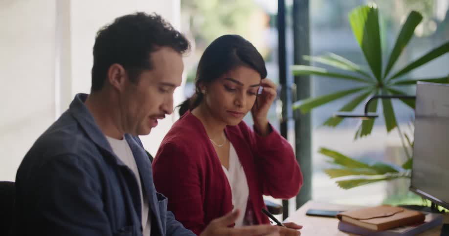 Man and woman are sitting at the computer desk together