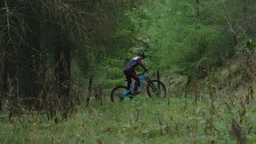 A male is doing tricks with his bicycle during spring