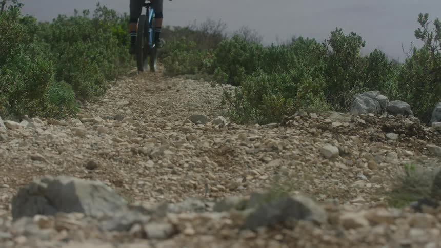 A person jumps up the hill on their bike
