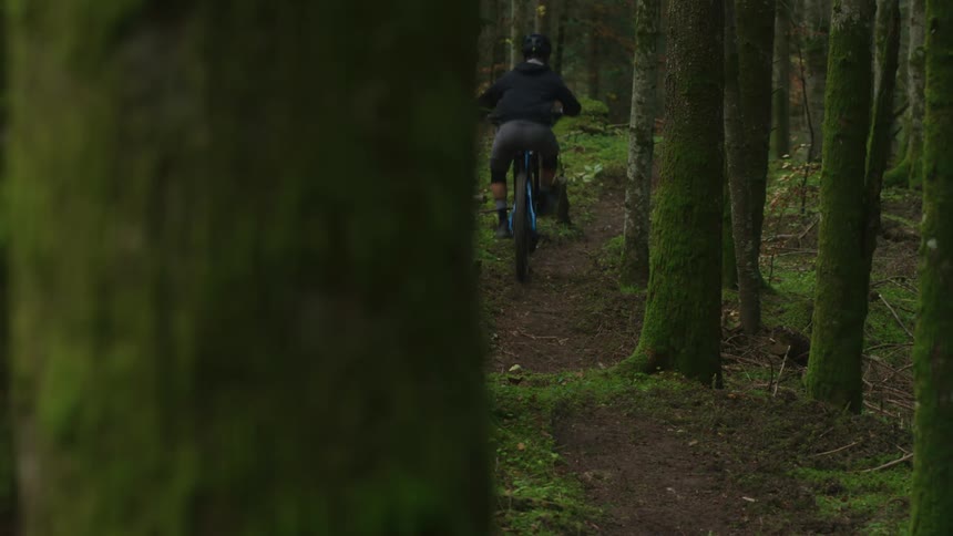 A person riding a mountain bike out in the forest