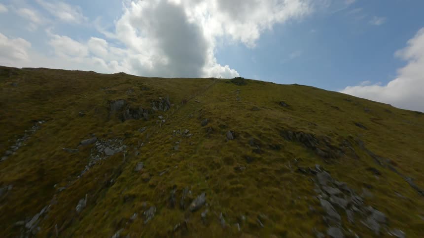 Aerial view of barren mountain slope against the sky