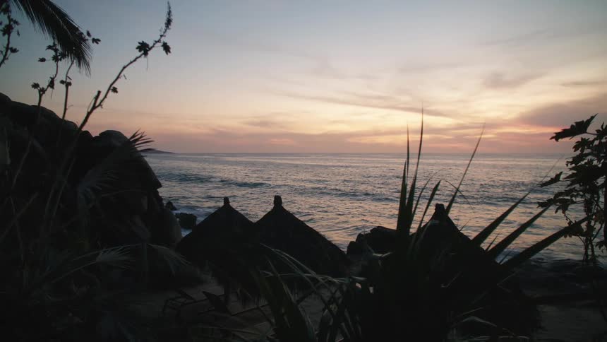 Beauty of a cool beach in the evening palm trees sway gently in the breeze while fluffy clouds float across the sky