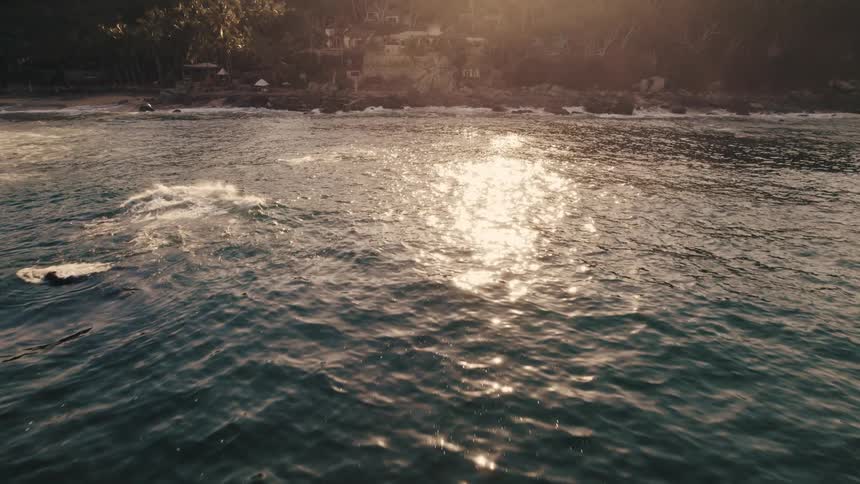 The sun is reflecting on the body of water at dusk