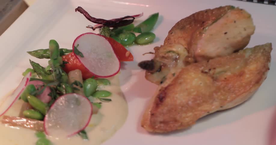 A chef is finishing up plating a meal