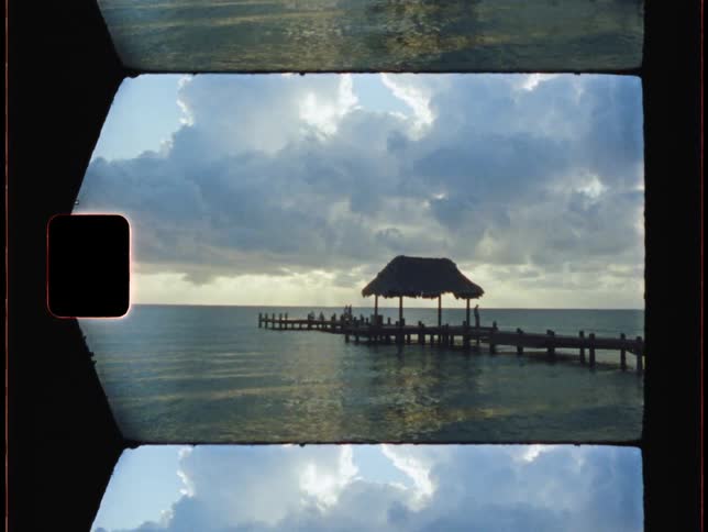 Landscape of pier and ocean against the cloudy sky