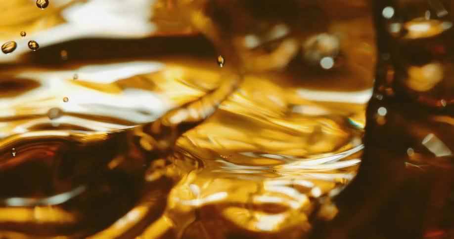 Drops fall in the gold liquid