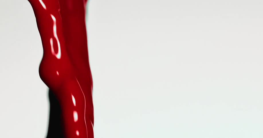 Red paint flowing on white background