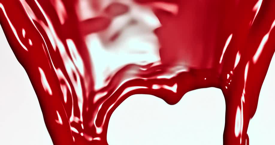 Crimson liquid reflects white light as it falls