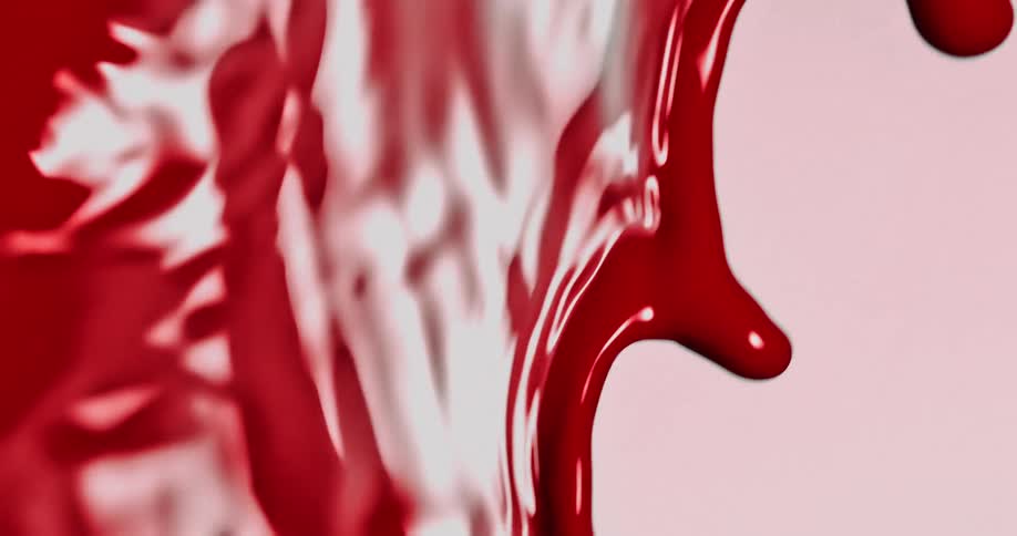 A close up of red paint being moved backward in slow motion