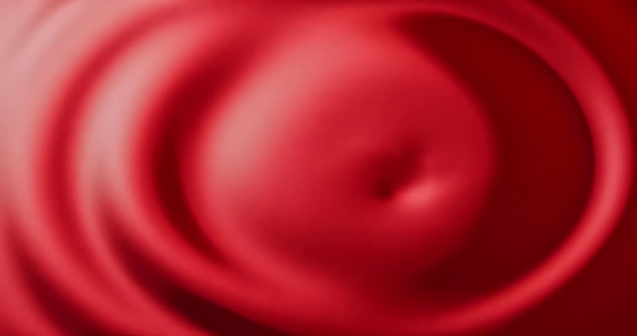 Red paint with a ripple created from the center and moving outward slowly