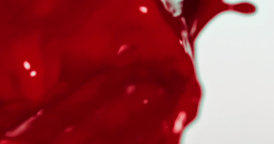 Red paint flowing on white background
