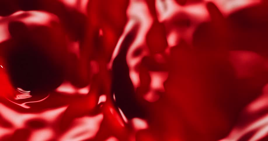 Crimson fluid churns reflecting light